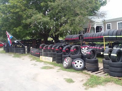 Display of used tires in front of Used tire shop in Farmington, Maine